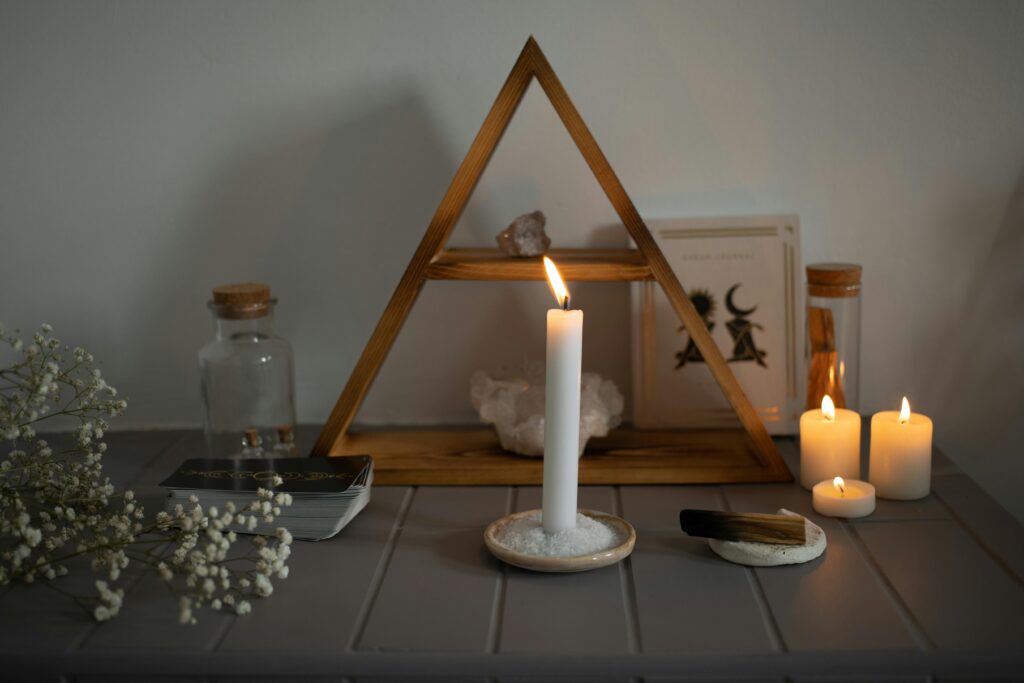 A serene spiritual setup featuring candles, crystals, and tarot cards arranged for meditation.