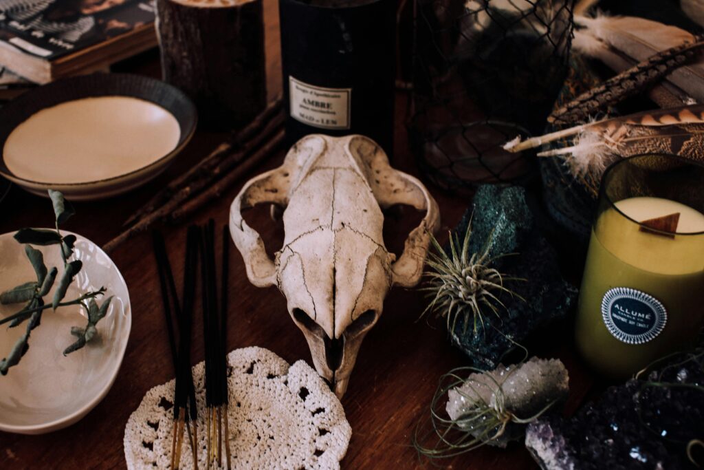 Eerie setup with skull and candles, evoking a mystical ritual or spooky atmosphere.